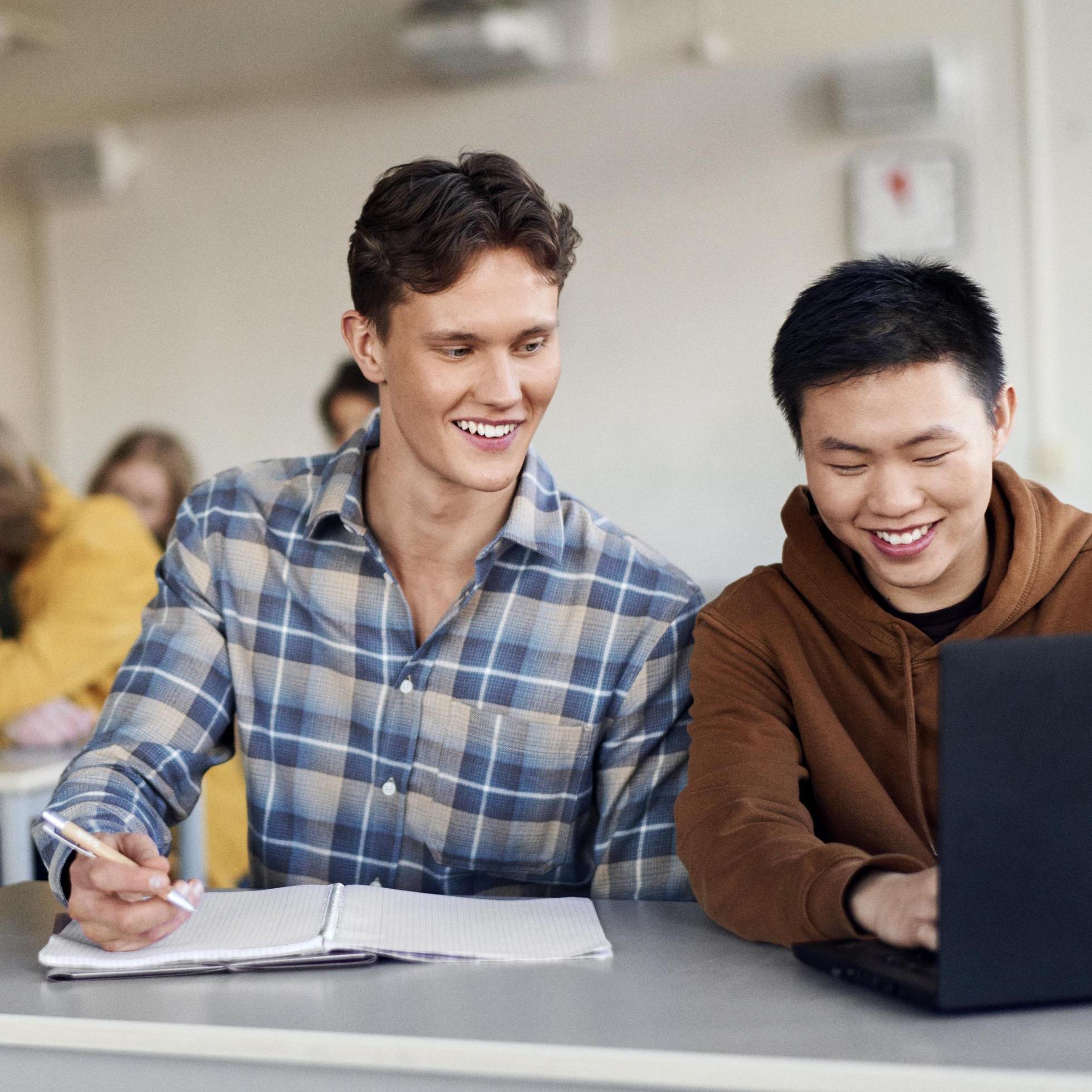 Students studying at a desk in classroom